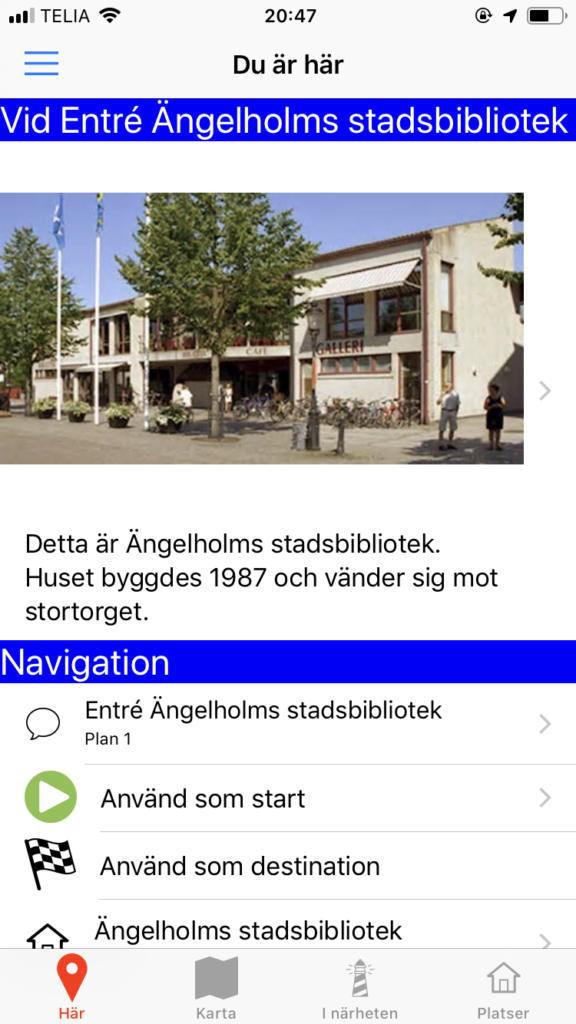 The image shows the Here view in the app with information about the entrance to Ängelholm's city library.